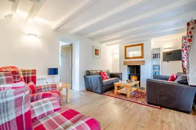 a living room with two couches and a fireplace at 3 Bed in Padstow oc-p00294 in Saint Issey