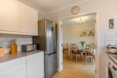 a kitchen with a stainless steel refrigerator and a dining room at 3 Bed in Padstow oc-p00226 in Padstow