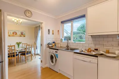a kitchen with a washer and dryer and a dining room at 3 Bed in Padstow oc-p00226 in Padstow