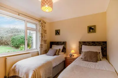 two beds in a room with a window at 3 Bed in Padstow oc-p00226 in Padstow