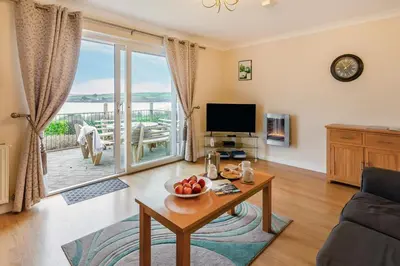 a living room with a table and a tv at 3 Bed in Padstow oc-p00226 in Padstow