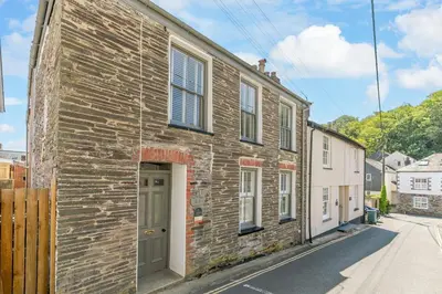 a brick building with a door on a street at 4 Bed in Padstow oc-p00297 in Padstow