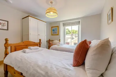 a bedroom with two beds and a window at 4 Bed in Padstow oc-p00297 in Padstow