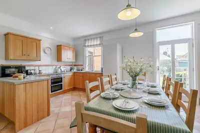 a kitchen and dining room with a table and chairs at 4 Bed in Padstow oc-p00297 in Padstow