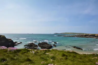 a view of a beach with rocks and the ocean at 3 Bed in Padstow oc-p00281 in St Merryn