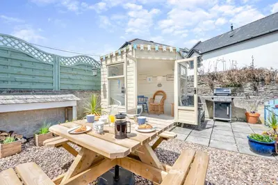 a patio with a picnic table and a grill at 3 Bed in Padstow oc-p00329 in Padstow