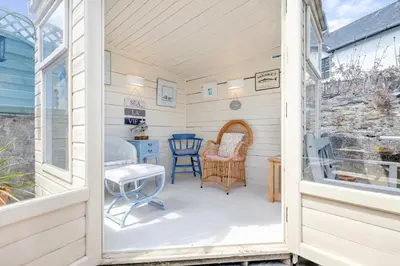 a room with a porch with chairs and a table at 3 Bed in Padstow oc-p00329 in Padstow