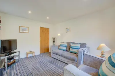 a living room with a couch and a tv at 1 Bed in Padstow oc-p00288 in St Merryn