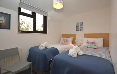 a bedroom with two beds with towels on them at 2 Bed in Padstow oc-p00330 in Padstow