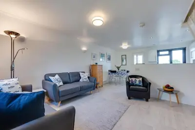 a living room with two blue couches and a table at 2 Bed in Padstow oc-p00330 in Padstow