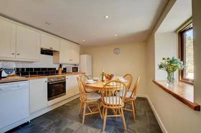 a kitchen with a table and chairs in a kitchen at 2 Bed in Padstow oc-p00282 in St Merryn