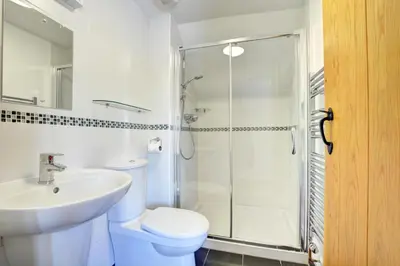 a bathroom with a toilet and a sink and a shower at 2 Bed in Padstow oc-p00282 in St Merryn
