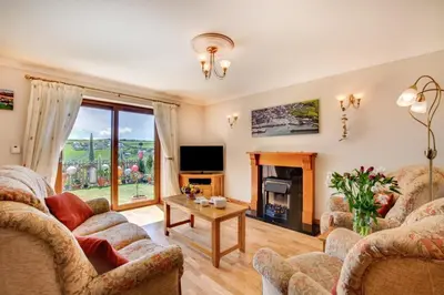a living room with two couches and a tv at 2 Bed in Newquay oc-p00335 in Mawgan Porth
