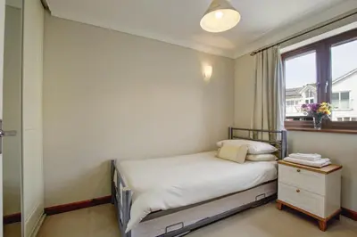 a small bedroom with a bed and a window at 2 Bed in Newquay oc-p00335 in Mawgan Porth