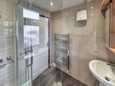 a bathroom with a glass shower and a sink at 2 Bed in Newquay oc-p00335 in Mawgan Porth