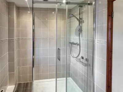 a shower stall with a glass door in a bathroom at 2 Bed in Newquay oc-p00335 in Mawgan Porth