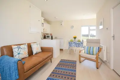 a living room with a couch and a chair at 2 Bed in Padstow oc-p00375 in Padstow