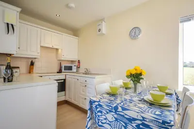 a kitchen with a table with a blue and white table cloth at 2 Bed in Padstow oc-p00375 in Padstow