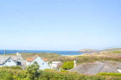 a town with houses and the ocean in the background at 2 Bed in Padstow oc-p00375 in Padstow