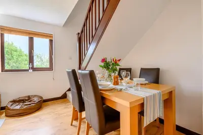 a dining room with a wooden table and chairs at 2 Bed in Padstow oc-p00385 in Padstow