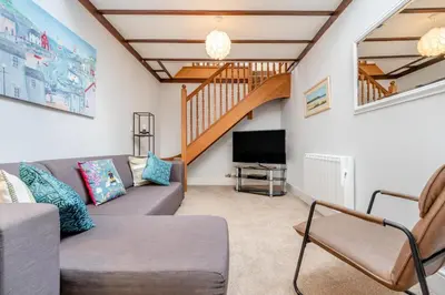 a living room with a couch and a television at 2 Bed in Padstow oc-p00398 in St Merryn