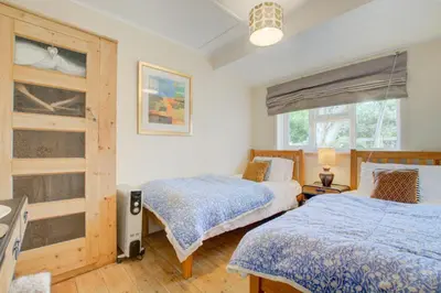 a bedroom with two beds and a window at 2 Bed in Newquay oc-p00359 in Mawgan Porth