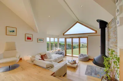 a living room with a couch and a fireplace at 3 Bed in Padstow oc-p00357 in St Merryn