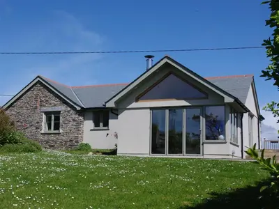 a house with large windows on a lawn at 3 Bed in Padstow oc-p00357 in St Merryn
