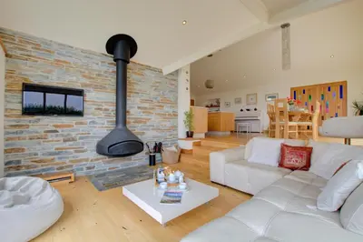 a living room with a white couch and a brick wall at 3 Bed in Padstow oc-p00357 in St Merryn