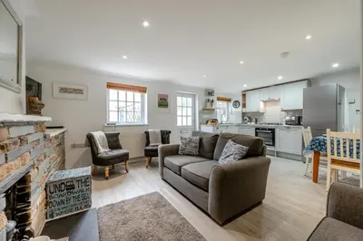 a living room with a couch and a kitchen at 3 Bed in Padstow oc-p00397 in Padstow