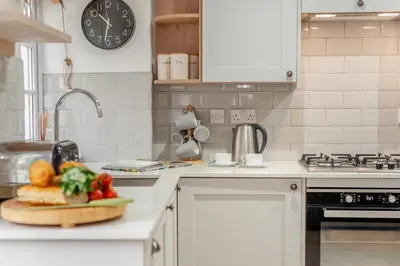 a kitchen with a plate of vegetables on a counter at 3 Bed in Padstow oc-p00397 in Padstow
