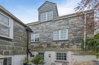 a brick house with a tower on top of it at 3 Bed in Padstow oc-p00397 in Padstow