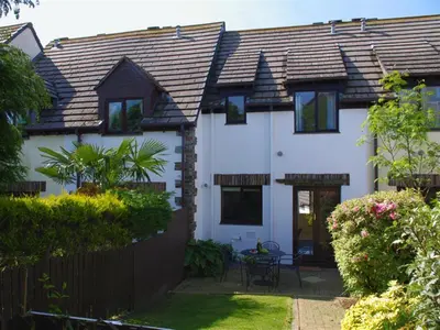 a white house with a fence and a yard at 2 Bed in Padstow oc-p00390 in Padstow