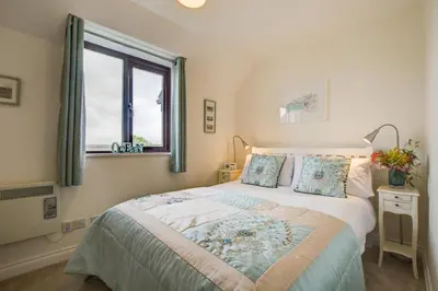 a bedroom with a large bed and a window at 2 Bed in Padstow oc-p00390 in Padstow