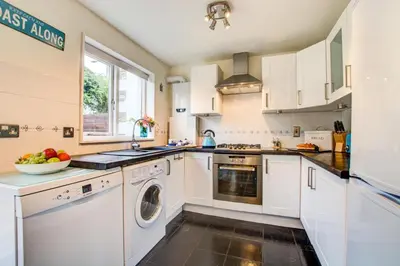 a kitchen with white cabinets and a dishwasher at 2 Bed in Padstow oc-p00390 in Padstow