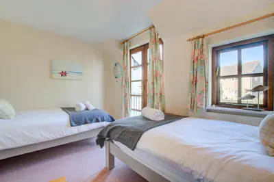 a bedroom with two beds and a window at 2 Bed in Padstow oc-p00424 in Padstow