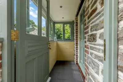 a hallway with a door and a brick wall at 2 Bed in Bodmin oc-p00405 in Bodmin