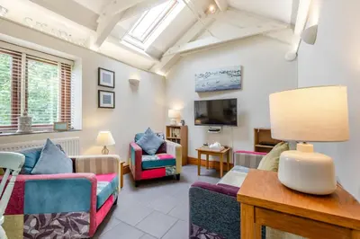 a living room with two chairs and a tv at 2 Bed in Bodmin oc-p00405 in Bodmin