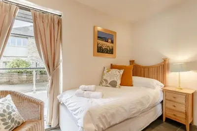a bedroom with a bed and a large window at 3 Bed in Wadebridge oc-p00421 in Saint Issey