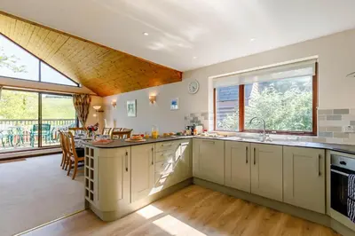 a kitchen with white cabinets and a large window at 3 Bed in Wadebridge oc-p00427 in Little Petherick