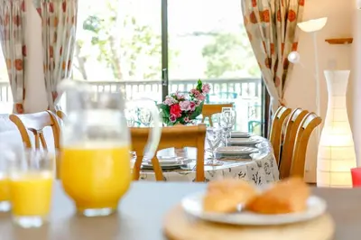 a table with a plate of food and orange juice at 3 Bed in Wadebridge oc-p00427 in Little Petherick