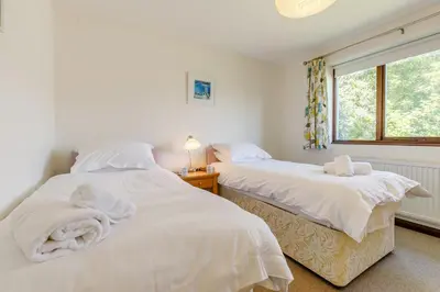 two white beds in a room with a window at 3 Bed in Wadebridge oc-p00427 in Little Petherick