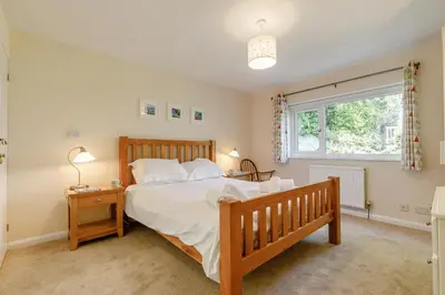 a bedroom with a large bed and a window at 3 Bed in Wadebridge oc-p00427 in Little Petherick
