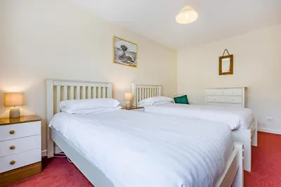 two white beds in a bedroom with red carpet at 4 Bed in Padstow oc-p00401 in Padstow
