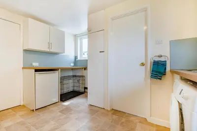 a kitchen with white cabinets and a door at 4 Bed in Padstow oc-p00401 in Padstow