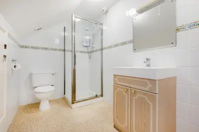 a bathroom with a shower and a toilet and a sink at 4 Bed in Padstow oc-p00401 in Padstow