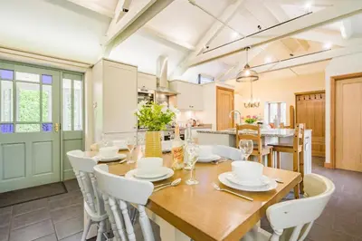 a kitchen and dining room with a wooden table and chairs at 3 Bed in Bodmin oc-p00437 in Bodmin