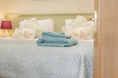a bed with blue towels on top of it at 3 Bed in Bodmin oc-p00437 in Bodmin