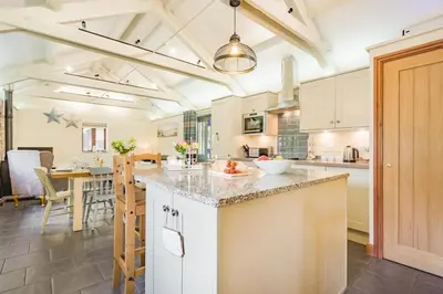 a kitchen with white cabinets and a large island at 3 Bed in Bodmin oc-p00437 in Bodmin