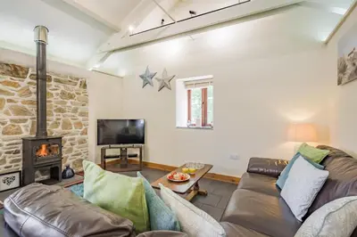 a living room with a couch and a fireplace at 3 Bed in Bodmin oc-p00437 in Bodmin